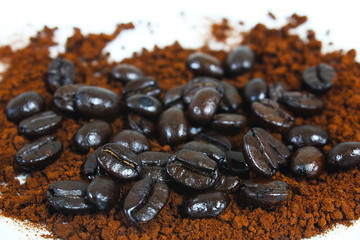 Dark brown roasted coffee beans and coffee powder