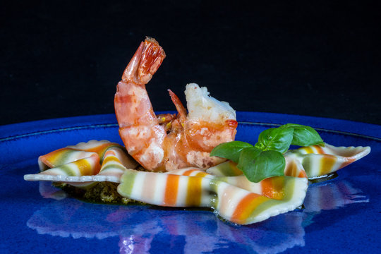 Colored Pasta With Shrimp On A Blue Plate