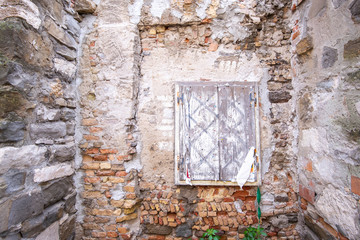 Alte verwitterte rustikale Ziegelmauer mit Fenster Holzläden als Hintergrund