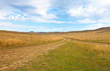 Dirt roads along the steppe part of Olkhon Islands on Lake Baikal. Beautiful steppe landscape. Natural background