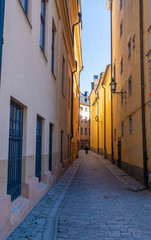 Fototapeta na wymiar Narrow street in Stockholm. The old town (gamla stan) of the Swedish capital. Photo of medieval architecture.
