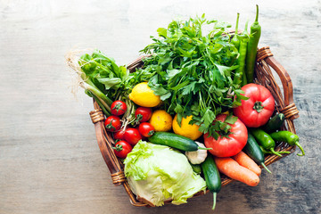Vegetables in the basket organic vegetables on wooden background