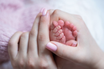 newborn baby feet in mother hands
