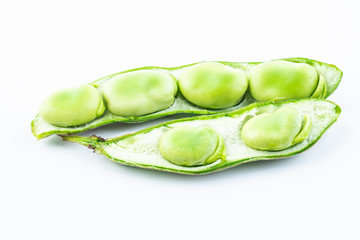 Closeup of fresh broad beans peeled on white background