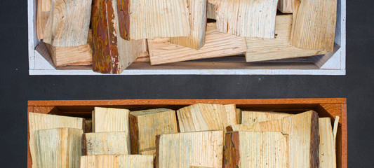 Wooden boxes with firewood on a black background.