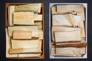 Wooden boxes with firewood on a black background.