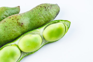 Closeup of fresh broad beans peeled on white background