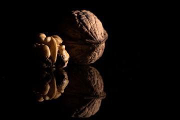 Deux noix sur fond noir avce reflet