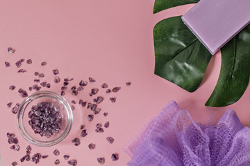 Natural organic cosmetic products with Monstera leaves on a pink background. Flat lay, top view, copy space. The concept of skin care and beauty. Spa home