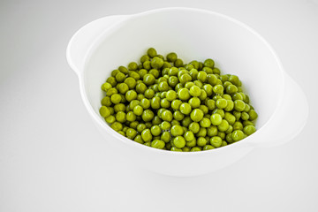 Green peas in a white plate