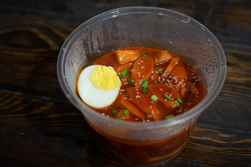 Take out Korean food Stir-fried Rice Cake Tteok-bokki in microwaveable container.