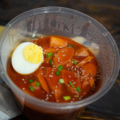 Take out Korean food Stir-fried Rice Cake Tteok-bokki in microwaveable container.