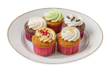 different cupcakes on a white plate isolated on white