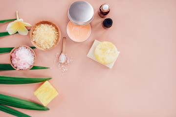 Flatlay composition with bowls of bath salt, serum, essential oil, solid shampoo and organic soap on pink color background. Spa and Beauty treatment. Zero waste, organic cosmetics concept.