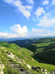 Mountain highway. The road through the mountains and gorges of the North Caucasus. View of the alpine mountains of the Caucasus in summer