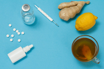 Mercury thermometer, glass bottle, pills and health remedy foods for cold and flu relief.