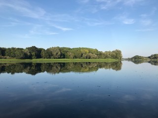 Obraz premium reflection of trees and sky in the river Loire, France