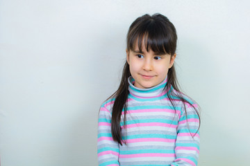 portrait of a child. Nice girl with long hair. Gray background