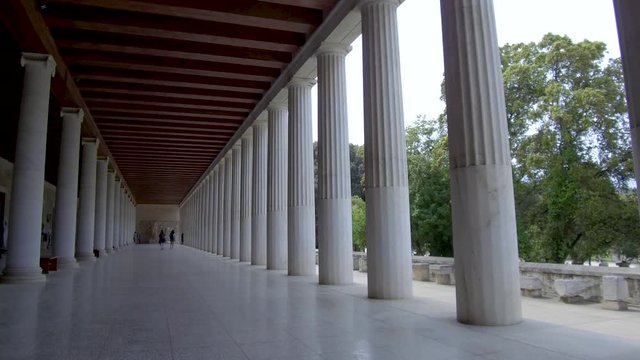 Tracking shot camera moves slowly forward in the interior length of Stoa of Attalos in Athens