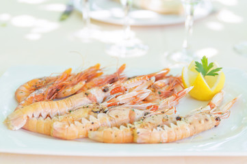 Shrimp and Spiny Lobster with Lemon Slice on White Plate
