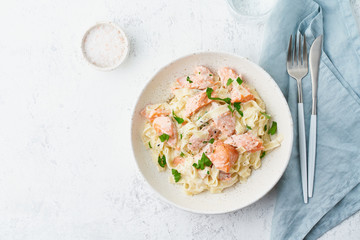 Salmon pasta, tagliatelle with fish and creamy sauce. Italian dinner with seafood