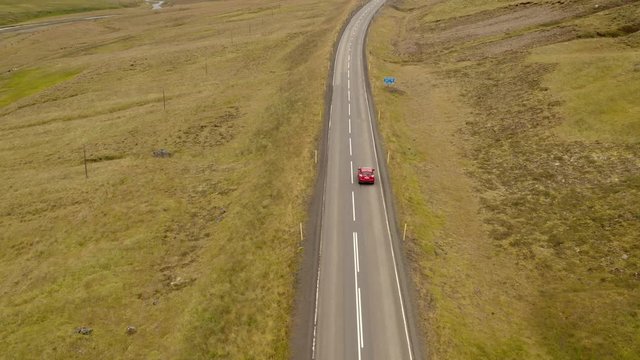 Red car on the road №1 in North Iceland by drone, Horgarsveit