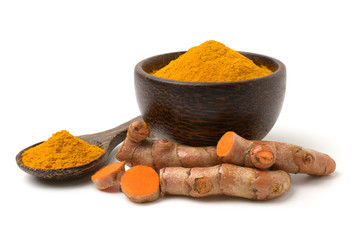 Turmeric (curcumin) powder and rhizomes isolated on a white background,Used for cooking and as herbal medicine,copy space.