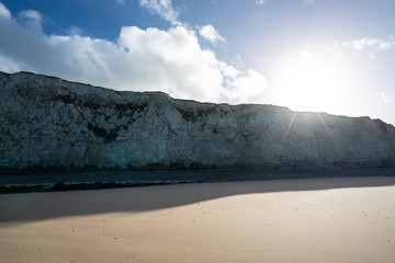 Fototapeta na wymiar Chalk cliffs at Escalles on the Opal coast in northern France close to Cap Blanc Nez with sun shining over the edge and blue skies with clouds