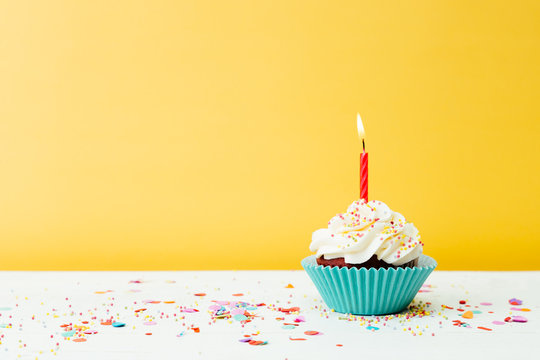 Birthday cupcake on yellow background