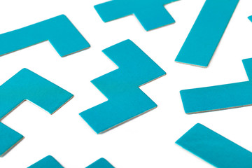 Various shapes, blue puzzle elements, pattern, white background abstract. Scattered unorganized parts, simple different unlinked disconnected figures, no connection, solving problems abstract concept