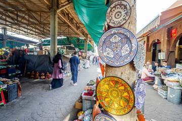 Traditional pottery for sale hanging on open air market in Agadir, Morocco