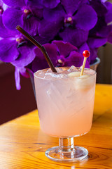 Purple orchid,Strawberry smoothie yogurt with peppermint leaves,Lychee juice,A glass of iced rose soda with lychee juice and lemon, decorated with petals rose on wooden table and copy space, 