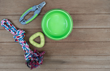 Bowl plastic and toy for pet  on wooden background