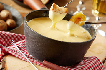 Steaming pot of creamy cheese fondue