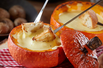 Traditional Swiss cheese fondue in a pumpkin