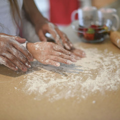 couple in love kneading the dough together