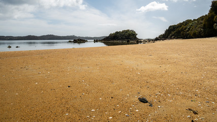 Remote beach with orange sand. Shot made on Ulva Island, Stewart Island (Rakiura) area, New Zealand