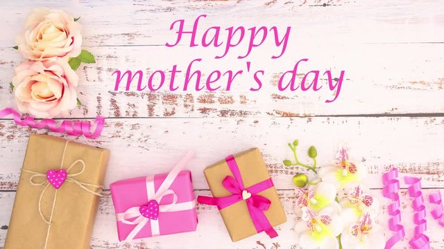 Happy mother's day - pink gifts and flowers on wooden table for mother's day - Stop motion 
