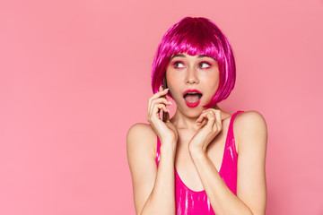 Image of young beautiful girl wearing wig talking on cellphone