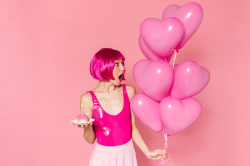 Image of surprised nice woman posing with balloons and cake