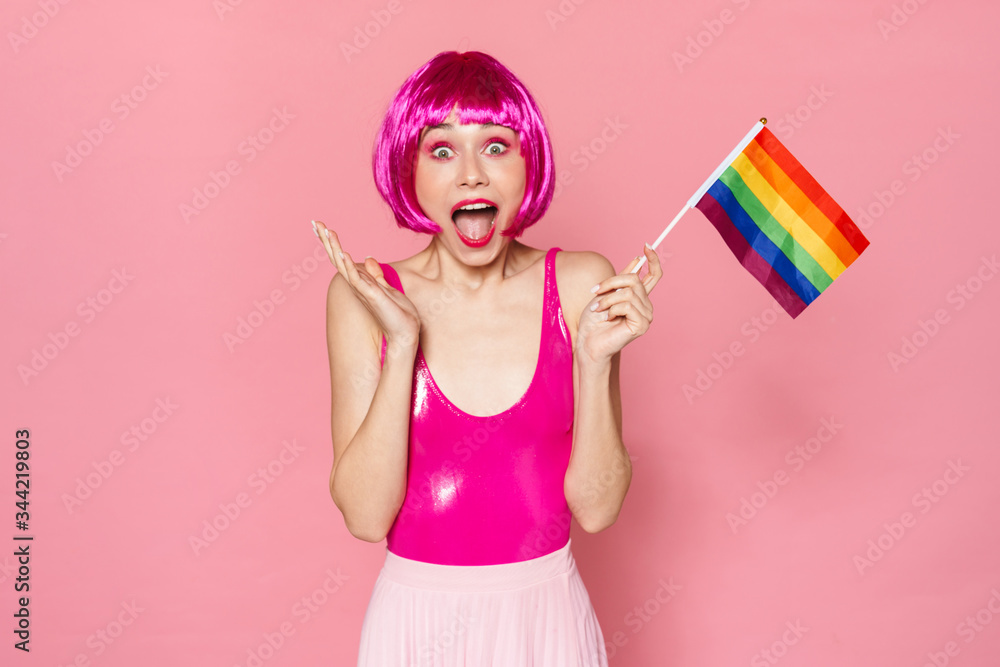 Poster image of happy woman expressing surprise and holding rainbow flag