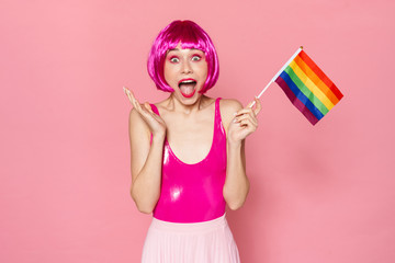 Image of happy woman expressing surprise and holding rainbow flag
