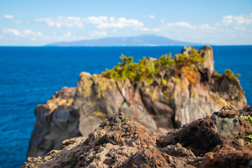 Ocean cliff with Izu-oshima island background in Izu peninsula, Shizuoka, Japan