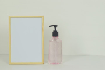 Frame mockup with alcohol gel Sanitizer hand gel cleaner on the side.