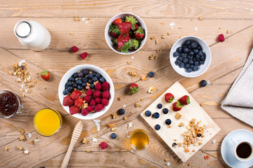 Morning breakfast with healthy food in a old wood background. Orange juice, cereal, milk, yogurt,...