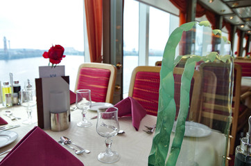 Formal dining room or restaurant on Hurtigruten cruiseship or cruise ship liner in red and white...