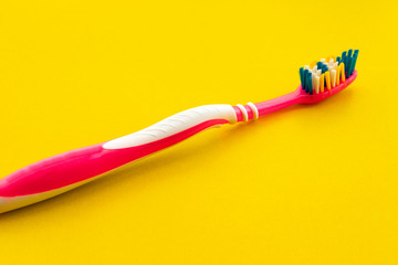 Toothbrush for personal care dental care on a yellow background. Bright toothbrushes for personal hygiene. Selective focus