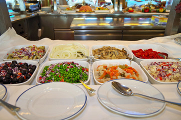 Delicious food and salad buffet in self service restaurant onboard Hurtigruten  cruiseship or...