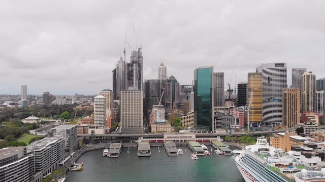View from above on Sydney city centre. In the frame skyscrapers, port, cruise liner and bay.