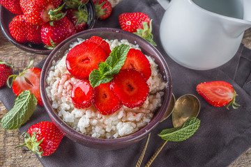 Summer morning rice pudding or rice porridge with strawberry and berry syrup in small bowl for, With milk and fresh strawberry copy space